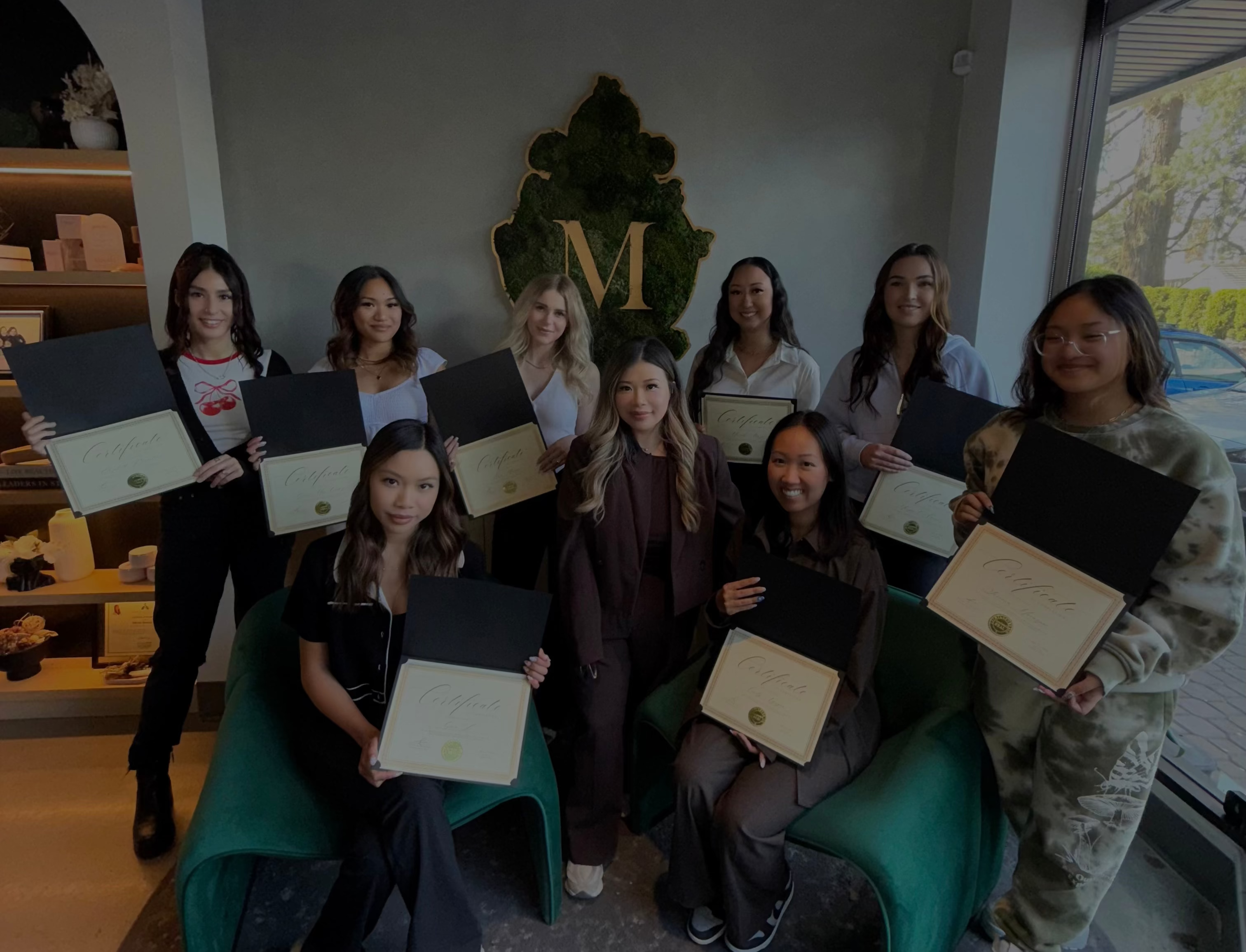 Group of women holding certificates in a room for a lash retention workshop