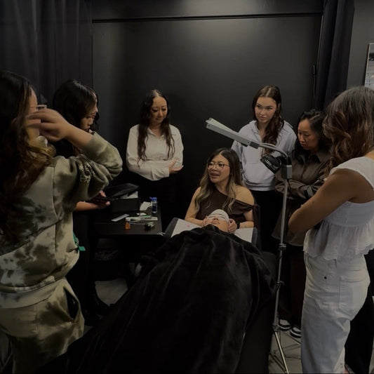 Group of women learning how to prolong eyelash extensions